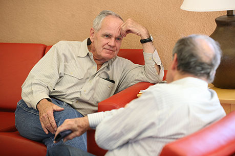 Men talking on a couch. Link to Gifts from Retirement Plans