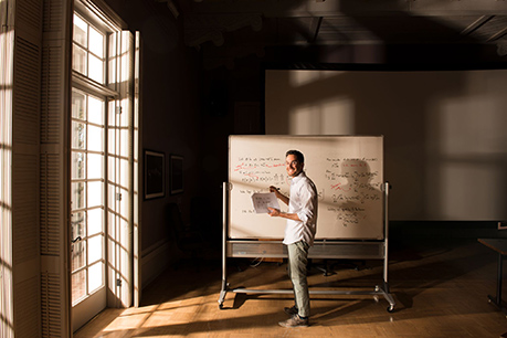 Man standing at a whiteboard. Link to Gifts from Retirement Plans